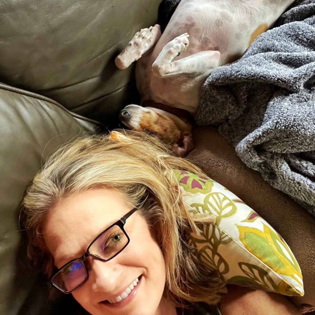 Kristen Levine napping with dog Tulip