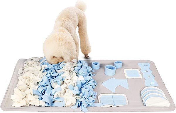 Photo of a large white poodle playing with a STELLAIRE CHERN Snuffle Mat